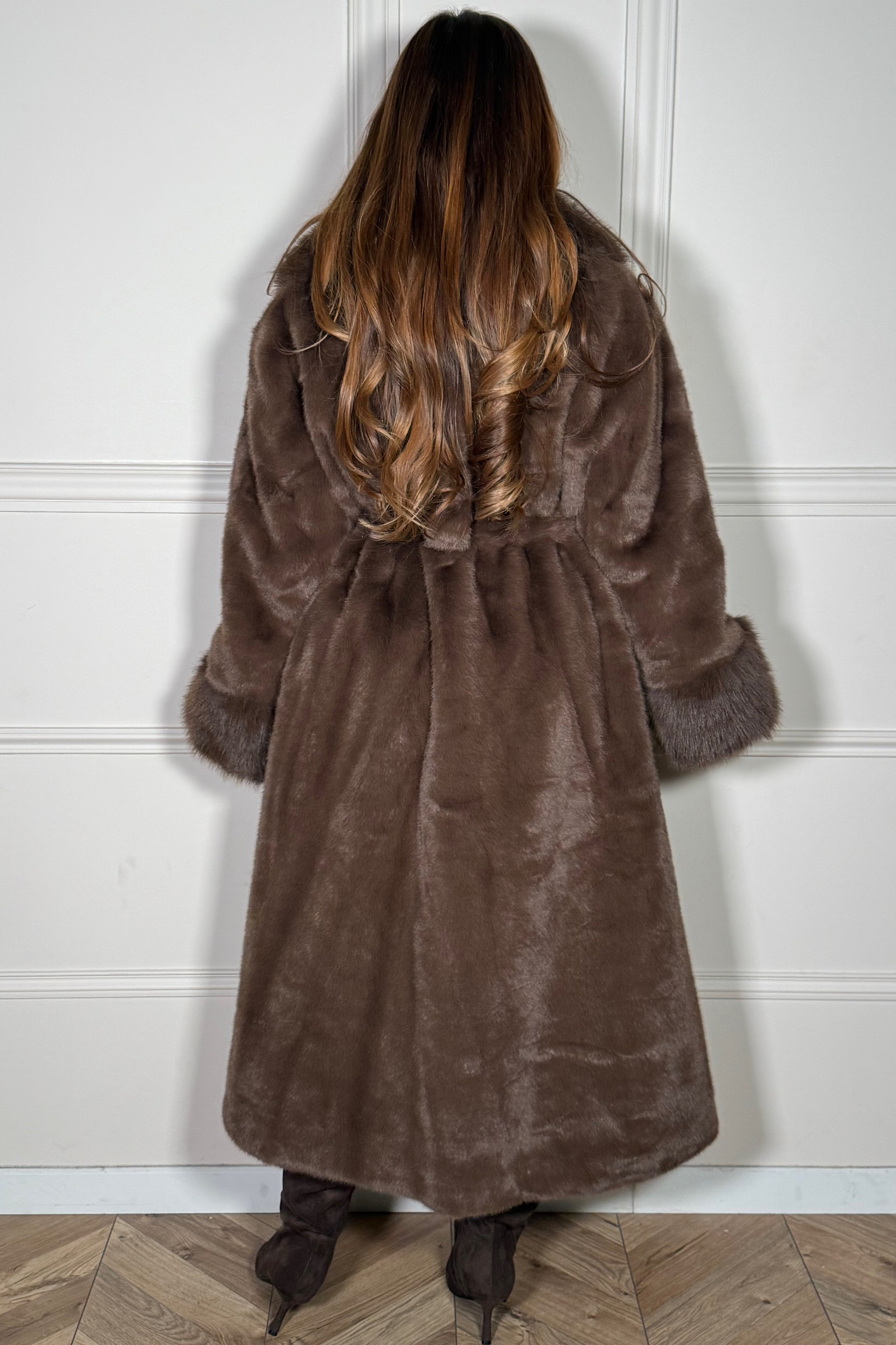 Manteau long en fausse fourrure porté avec ceinture, vue de profil, silhouette structurée et glamour